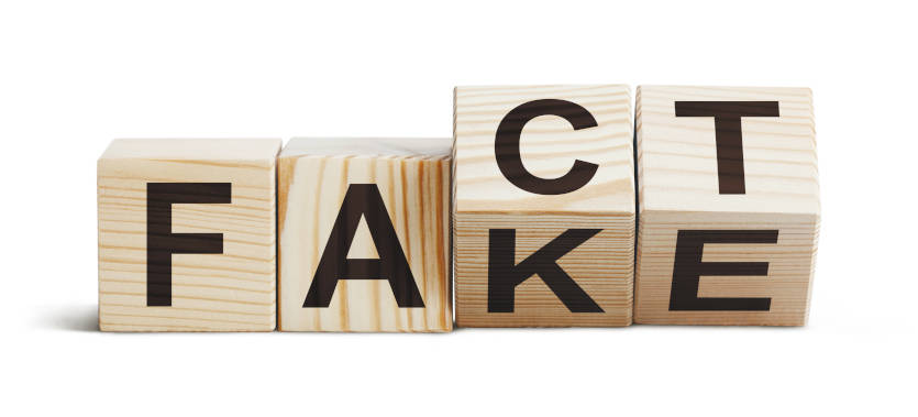 Wooden blocks with black lettering that can be rearranged to spell out the words fact or fake.